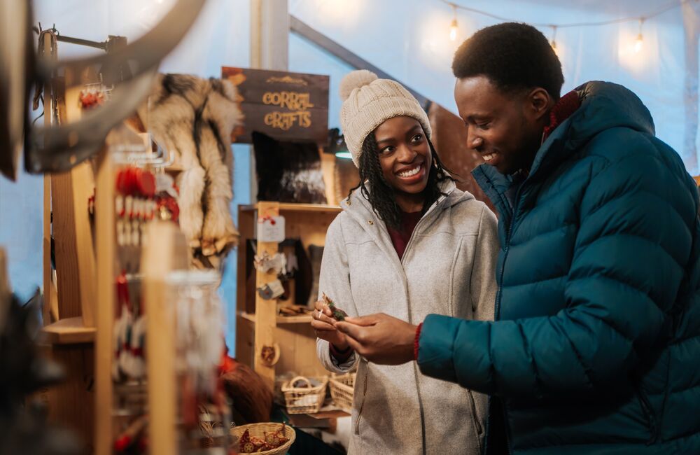 A couple looks at Christmas gifts at the Banff Christmas Market in Banff National Park.